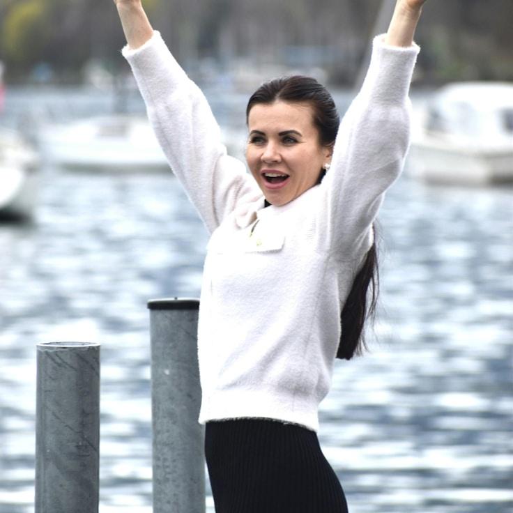 Avery Lin, Lead Design Curator at Coast Field Lab, reviewing corporate floral arrangements